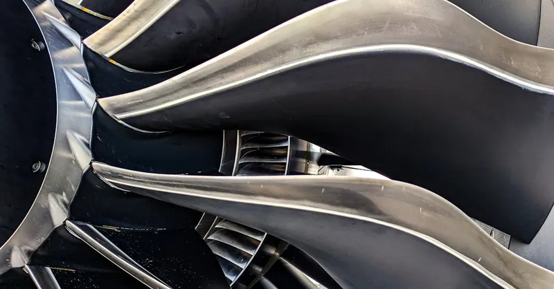 Detailed close-up of metal turbine blades showcasing engineering and aerodynamic design.