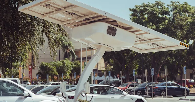 Modern solar-powered charging station for electric vehicles on a sunny day.