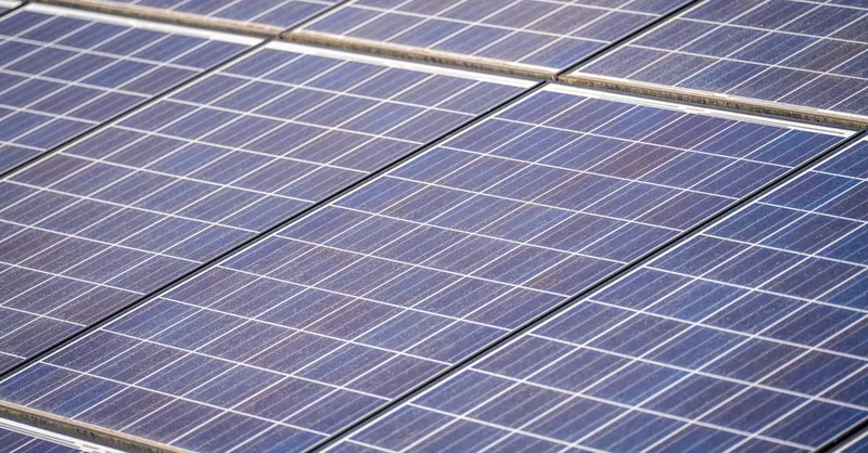 Detailed view of solar panels in a solar farm highlighting renewable energy technology.