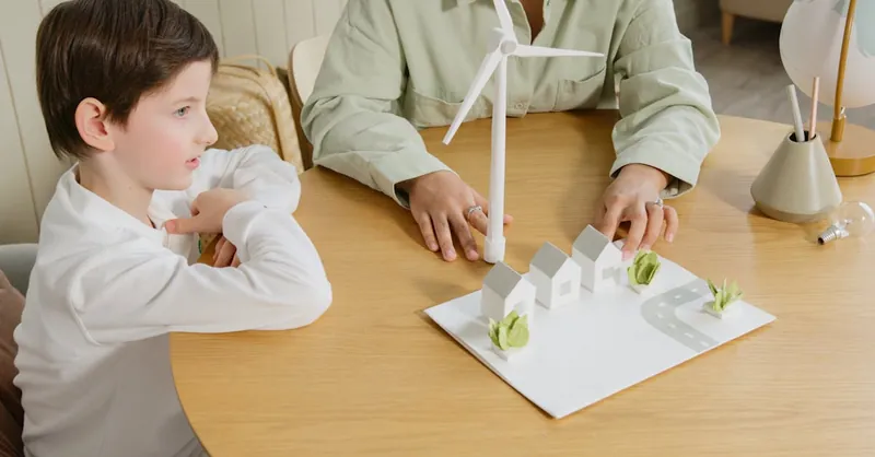 A child explores renewable energy models in a classroom setting.