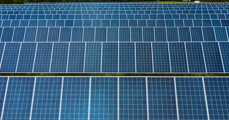 Contemporary installation of solar panels mounted on field in environmental friendly solar power station